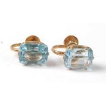 A pair of yellow metal aquamarine earrings, each featuring an octagonal cut aquamarine in a six claw