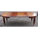 A Victorian mahogany extending dining table, the wind-out top having three extra leaves, each with a