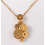 An 18ct yellow gold Cicladi pendant by Bulgari, featuring seven rotating discs of varying sizes,