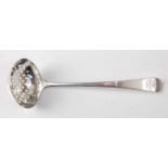 A George III silver sifting spoon, in the Old English pattern, with crested terminal and 'star'