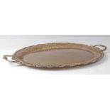 An early 20th century continental silver drinks tray, of twin handled oval form, having reeded
