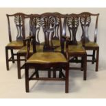 A set of six George III mahogany dining chairs, having pierced vase splat backs, leather upholstered