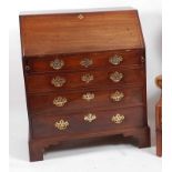 A George III mahogany writing bureau, the hinged fall opening to reveal fitted interior, above