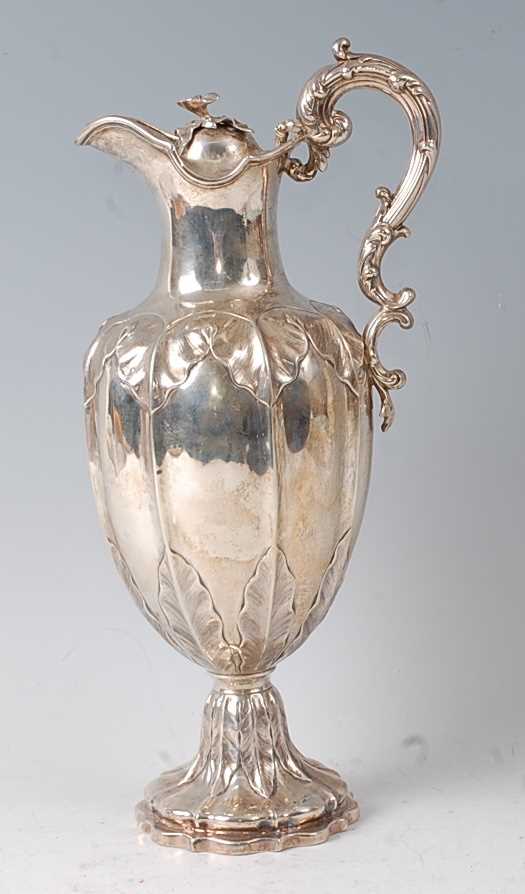 A Victorian silver claret jug, the lobed body with chased floral decoration, raised on a spreading - Image 4 of 5