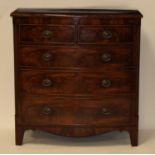 A late Regency mahogany bowfront chest, having two short and three long graduated drawers within