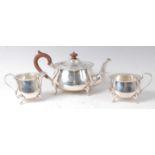 A George V silver three-piece tea set, comprising teapot, twin handled sugar and cream, each of