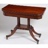 A Regency mahogany card table, the rectangular fold-over top with canted corners opening to reveal a