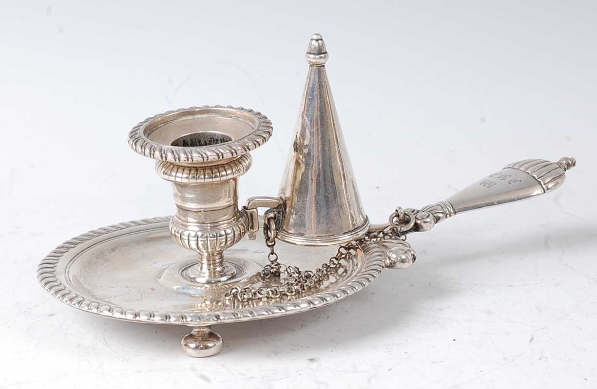 A William III silver chamberstick, of circular form with gadrooned border, the scroll mounted