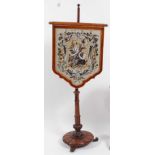 A William IV rosewood pole screen, the adjustable shield shaped screen embroidered with shells