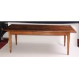 An 18th century French joined cherry wood refectory table, the three plank top having cleated ends
