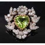 A yellow and white metal, peridot and diamond floral brooch, featuring a centre heart shaped peridot