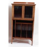 An Edwardian rosewood and bone strung music cabinet, the upper section enclosed by a pair of