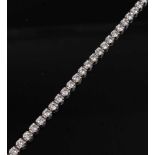 An 18ct white gold diamond tennis bracelet, featuring fifty-two round brilliant cut diamonds in claw