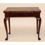 A George III mahogany card table, the fold-over top with proud corners, on single gateleg rear