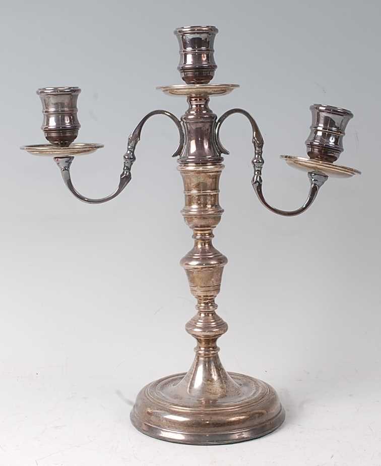 A silver three-light candelabrum, in the early 18th century style, having detachable sconce and on
