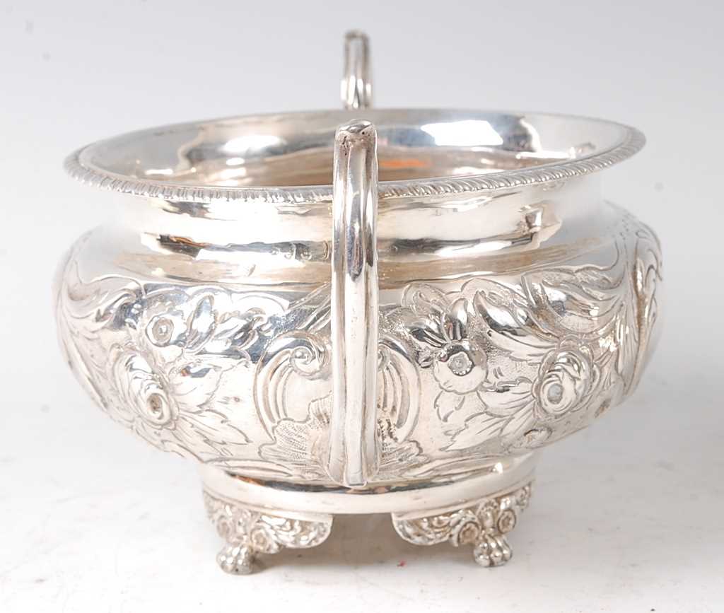 A George III silver twin handled sugar bowl, of squat circular form, having floral repousee - Image 2 of 2