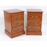 A pair of oak, burr oak and crossbanded bedside chests, each having a brushing slide above three
