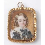 An early 19th century yellow metal miniature portrait memorial pendant, depicting a child's