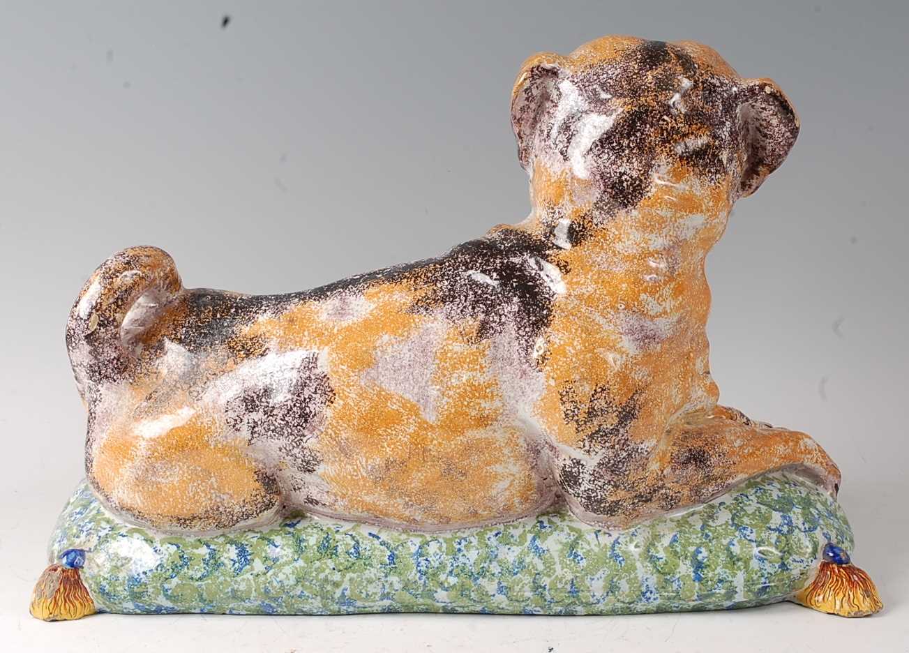 A French faience model of a recumbent pug dog upon a cushion, having all-over sponged decoration ( - Image 2 of 3