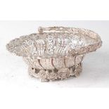 A George II silver sweetmeat basket, of shaped and pierced oval form, the swing handle modelled as