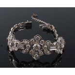 A white metal Art Deco diamond bracelet, featuring three graduated lozenge shaped sections grain set