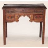 A George III mahogany lowboy, the top having a moulded edge over three frieze drawers with fret