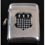 An Edwardian silver vesta, of hinged rectangular form, the front enamel decorated with the arms of