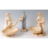 A pair of Royal Worcester figural comports by James Hadley, modelled as a boy and girl seated upon a