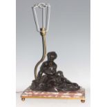 An early 20th century French bronze, rouge marble and gilt brass table lamp, the stepped base