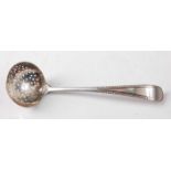 A George III silver sifting spoon, of small proportions, in the Old English pattern with beaded