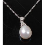 A white metal, pearl and diamond pendant, the pendant comprising a pearl drop measuring 13 x 10.5mm,