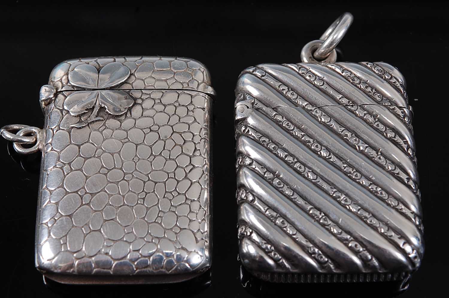 A late 19th century French silver vesta, of hinged rectangular form, surmounted by a four-leaf