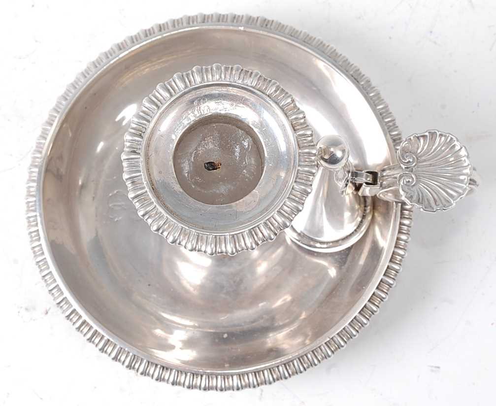 An early 19th century silver chamberstick, the whole having gadrooned edge and shell capped loop - Image 2 of 3
