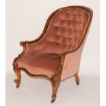 A Victorian mahogany spoonback nursing chair, the swept arms having leaf carving, the whole re-