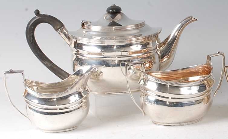 A silver three-piece tea set, in the early 19th century style, comprising teapot, twin handled sugar