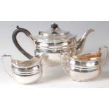 A silver three-piece tea set, in the early 19th century style, comprising teapot, twin handled sugar