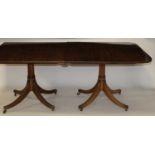 A mahogany triple pillar pedestal dining table, in the Regency style, the top having a reeded edge