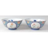 A pair of Chinese porcelain powder-blue ground 'medallion' bowls, each enamel decorated with
