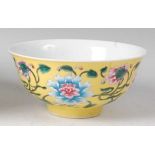 A Chinese porcelain yellow ground bowl, enamel decorated with flowering branches, four character