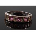 An 18ct white gold, pink sapphire and diamond half hoop eternity ring, featuring three rectangular