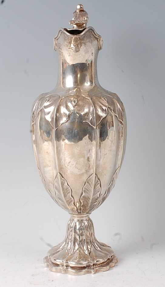 A Victorian silver claret jug, the lobed body with chased floral decoration, raised on a spreading - Image 2 of 5