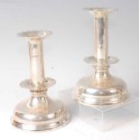 A pair of Edwardian silver candlesticks, in the 17th century style, with double wavy sconces and