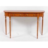 A Victorian style satinwood bowfront hall table, of narrow proportions, fitted with two frieze