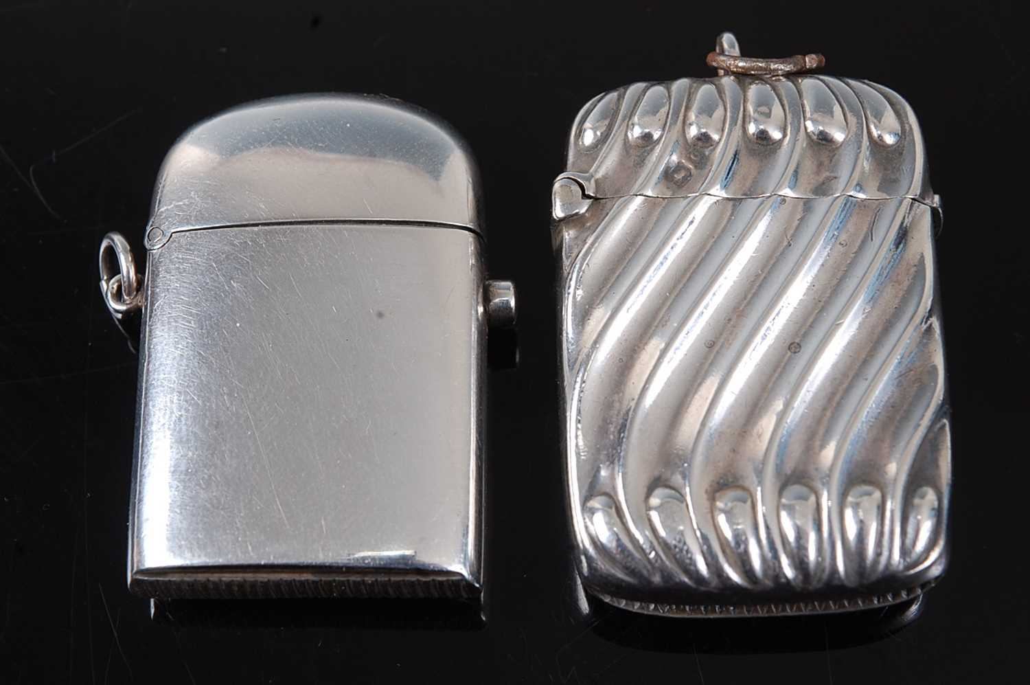 A late Victorian silver vesta, of plain undecorated hinged rectangular form, with domed cover and