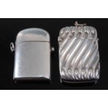A late Victorian silver vesta, of plain undecorated hinged rectangular form, with domed cover and
