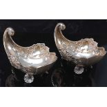 A pair of Russian silver shell shaped small dishes, each with further scroll leaf chased