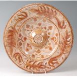 A Hispana Moresque lustre ware charger, Spain, 16/17th century, decorated with flowers and