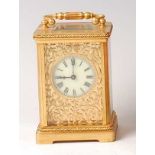 A circa 1900 French lacquered brass carriage clock, the white enamel dial within an applied leaf and
