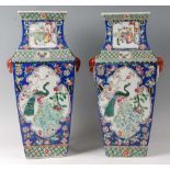 A pair of circa 1900 Chinese Canton vases, each of square section and enamel decorated with reserves