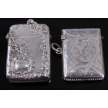 A late Victorian silver vesta, of hinged rectangular form, relief decorated with flowers and C-